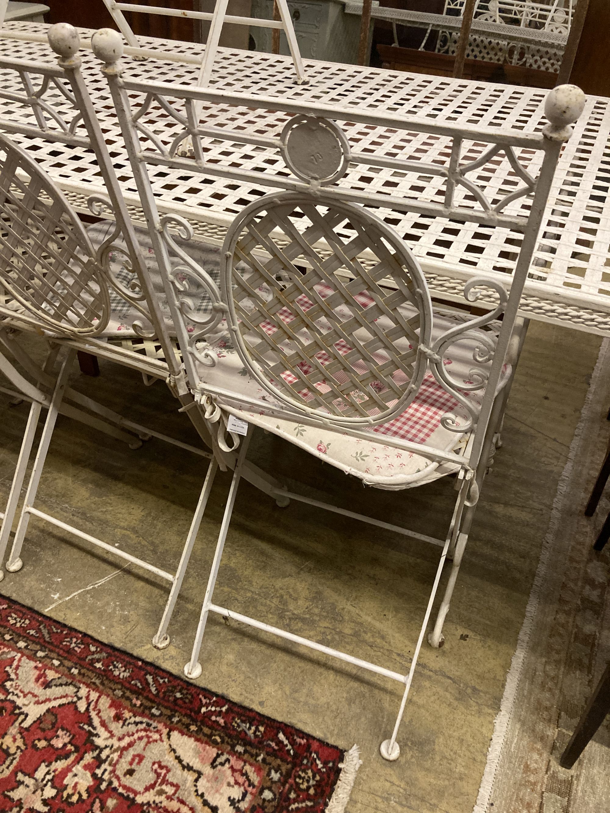A painted metal rectangular garden table, length 152cm, depth 76cm, height 76cm together with four matching folding chairs